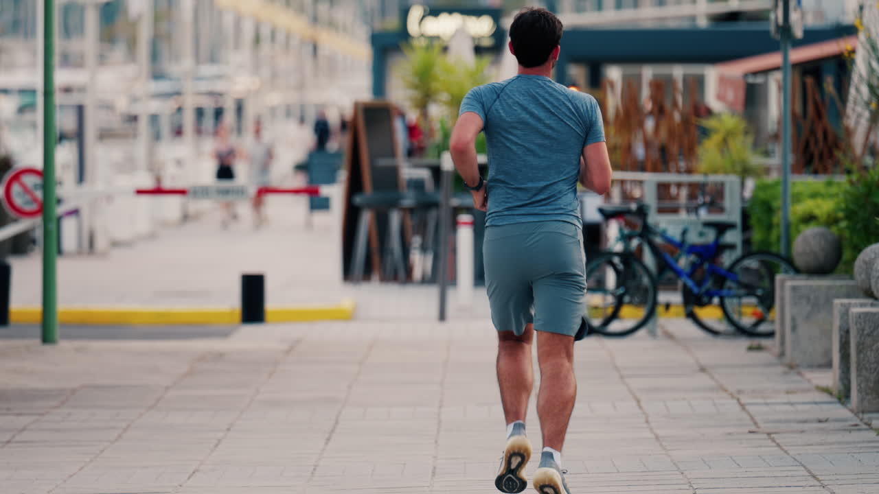 Cannes, France - May 13, 2025: Man running on the streets of the city in the daylight