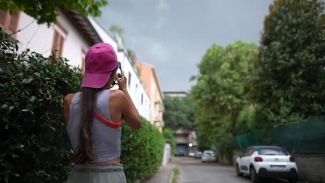 woman taking photo in the city street