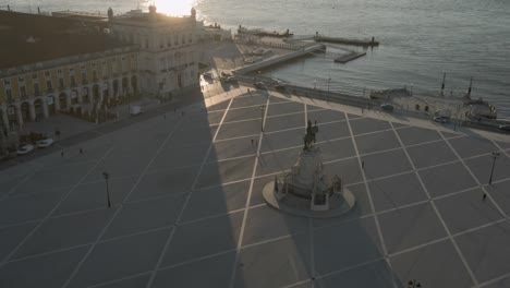 areal drone footage of the historical center praca do comercio town square in lisbon, portugal, filmed during sunset