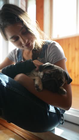 girl cuddling a puppy