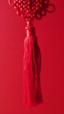 vertical video of close up of chinese decoration on red background