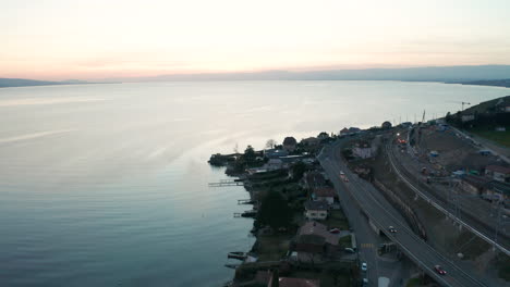 Aerial-reveal-of-large-lake-near-small-town