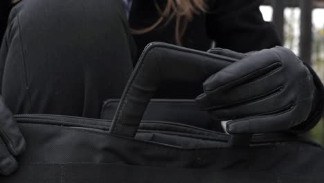 business woman with briefcase and gloves close up shot