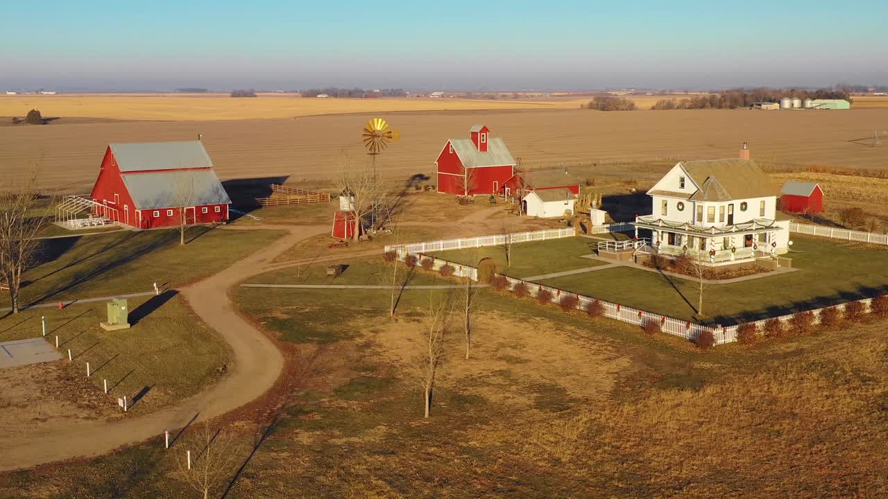 A drone aerial establishing shot over a classic beautiful farmhouse farm and barns in rural midwest America York Nebraska 7