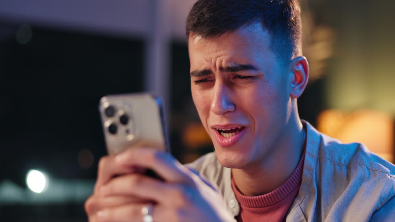 Worried man looking at his phone