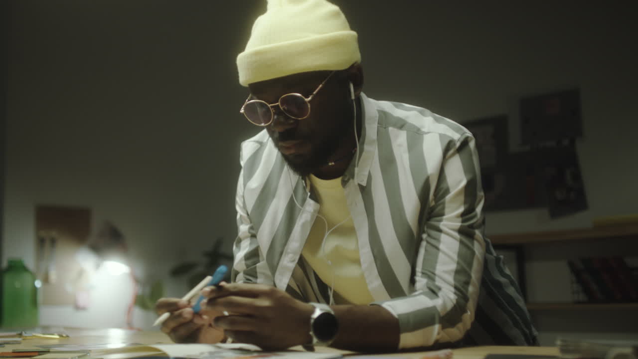 Man drawing or working creatively at a desk