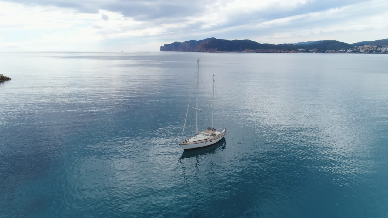 Ripresa con drone che vola intorno a una barca solitaria in mezzo al mare, 4K UHD