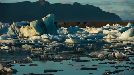 icebergs in a glacier lagoon at sunset