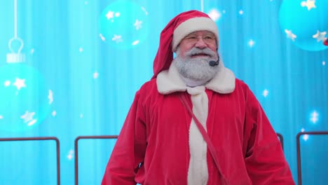 Happy Santa Claus in a Festive Costume Talking into a Microphone on a Blue Background Happy Santa Claus in a Festive Costume Talking into a Microphone on a Blue Background High Quality Footage