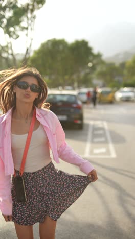 young woman in pink shirt and floral skirt