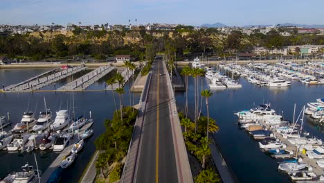 Aerial-dolly-along-bridge-and-roadway-separating-full-and-empty-docks