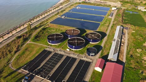 aerial view of sewage treatment facilities nearby black sea coastline and batumi urban skyline