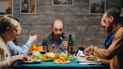 husband and wife clinking a glass of red wine