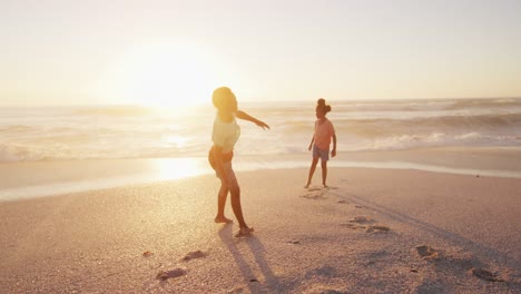 Lächelnde-Afroamerikanische-Geschwister-Heben-Die-Hände-Und-Spielen-Am-Sonnigen-Strand