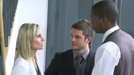 close up of businesswoman and businessmen speaking on stairs