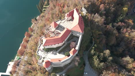 aerial rising over european castle directly above slovenia sunny day