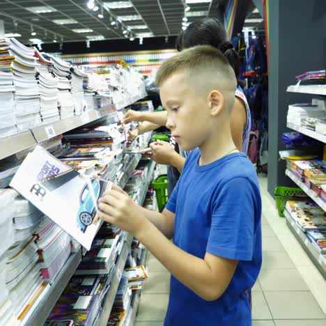 vinnitsa, ukraine - august, 2018: little boy is buying stationery for school. back to school concept.