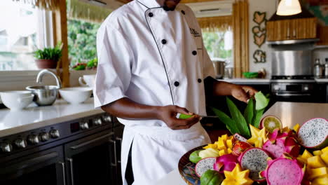 chef preparing a colorful fruit platter
