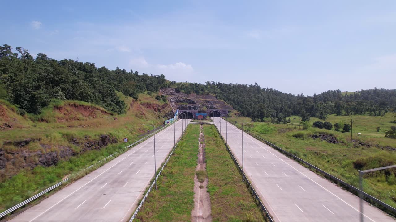 Tunnels on Igatpuri Kasara section of Samruddhi Mahamarg expressway construction over a forest area connecting Mumbai and Nagpur, Maharashtra, Establishing drone shot