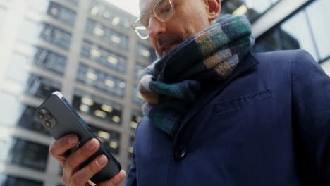 businessman using smartphone in city