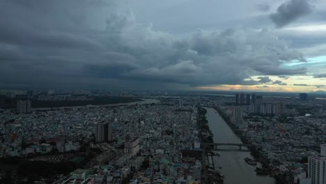 saigon or ho chi minh city, vietnam aerial tracking shot on very dark stormy evening