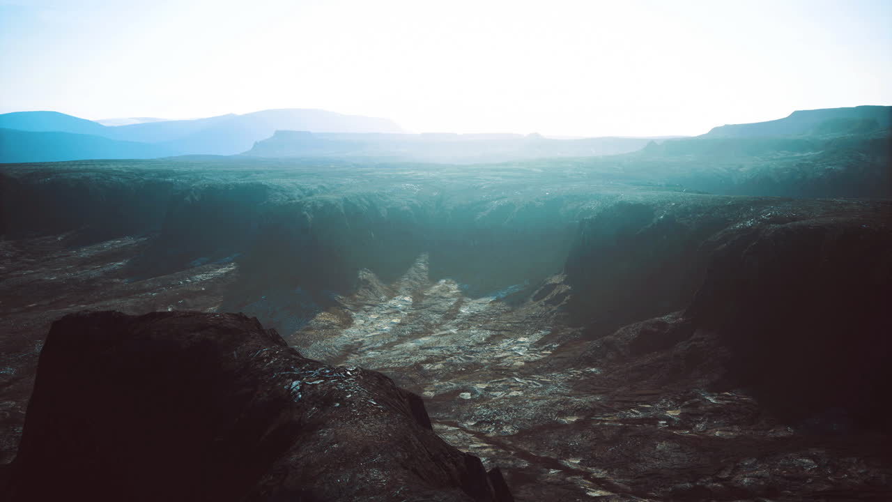 Vast canyon landscape with soft light creating a serene atmosphere at dusk