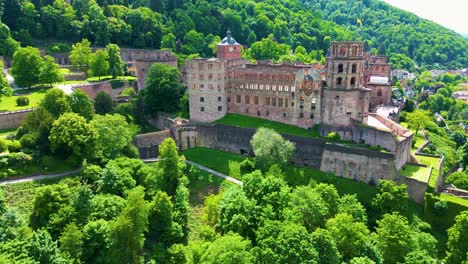 4k aerial drone video of ruins and gardens of the historic castle on königstuhl hill overlooking heidelberg, germany