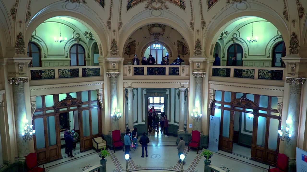Tilt up of a group of people on a tour of the Intendencia de Santiago, heritage day, Santiago, Chile.