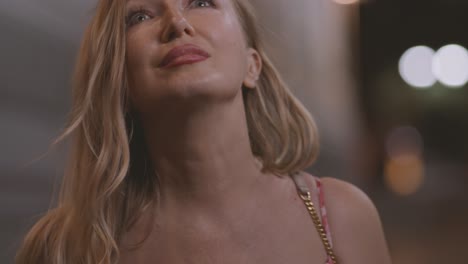 blond woman looking away walking on the street