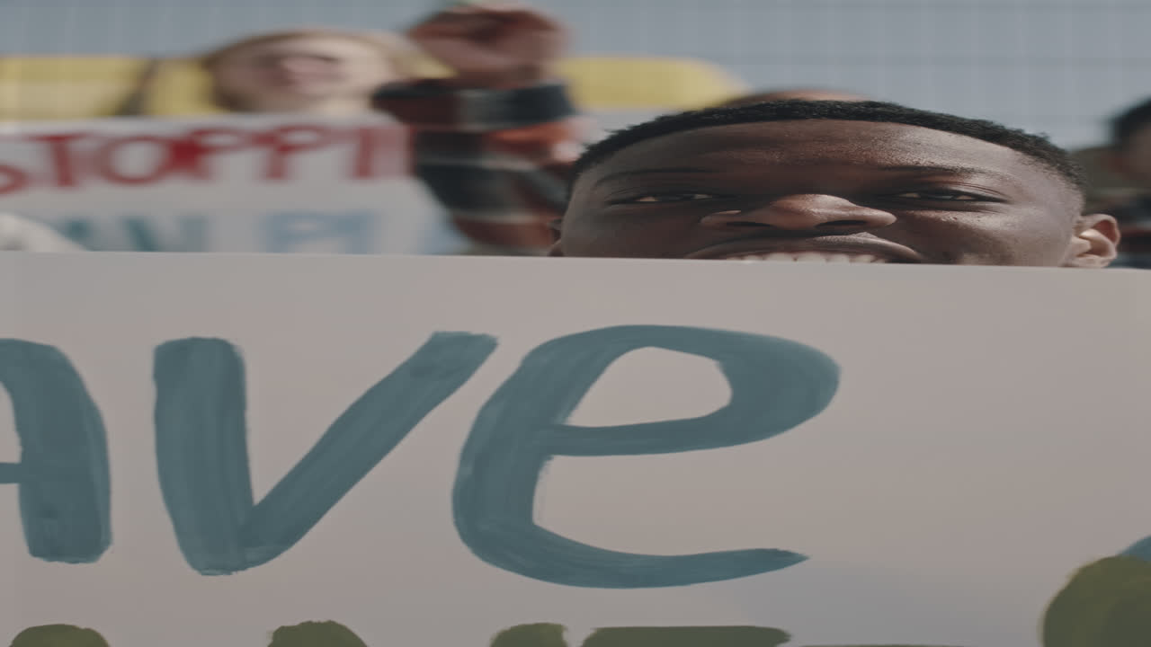 Environmental Activist Chanting Slogan with Poster