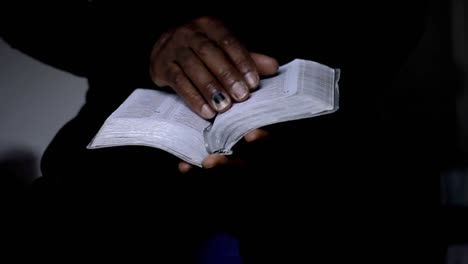 man-praying-with-bible-with-black-background-with-people-stock-video-stock-footage