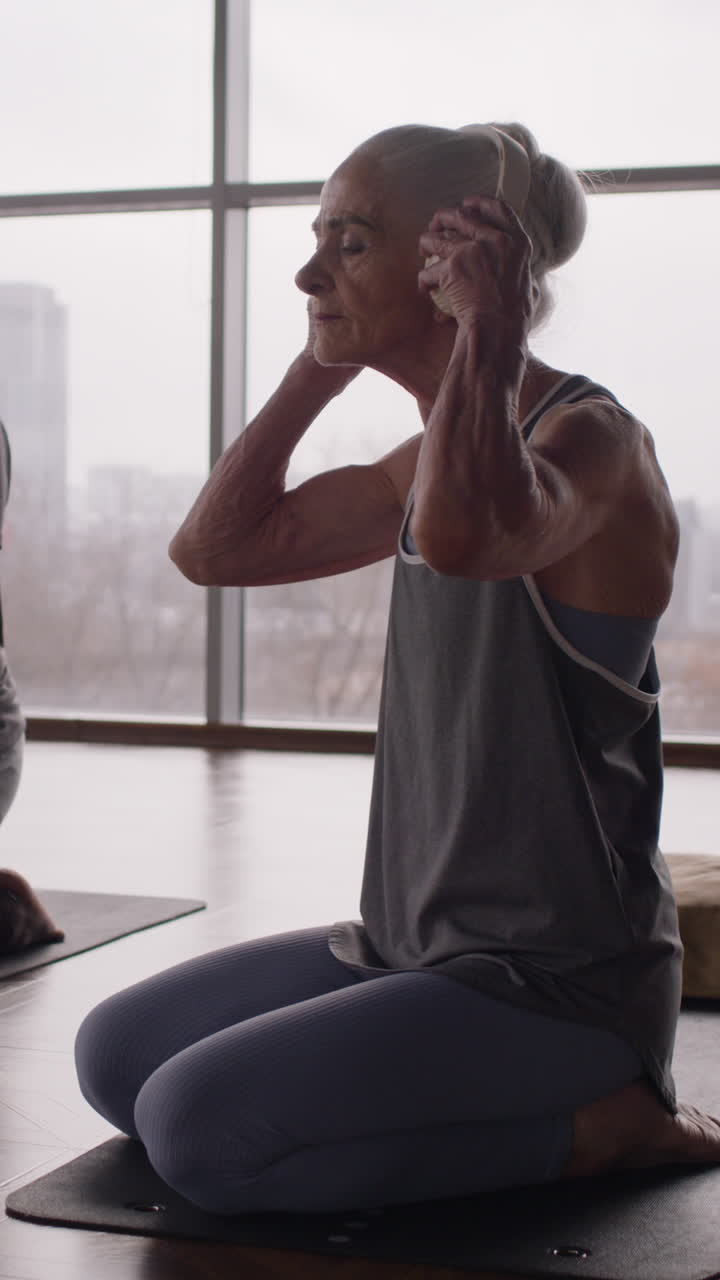 Senior Woman Meditating in Yoga Class