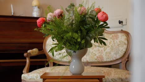 slow establishing shot of vase of colourful roses on display in a antique villa