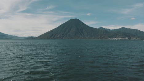 drone aerial revealing shot of san pedro volcano in lake atitlan, guatemala