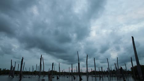 apocalyptic dramatic clouds and sunset over lake, time-lapse.