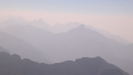 layers of mountain ridges in the hazy light from the top of fansipan, the highest mountain in indochina located in sapa, vietnam