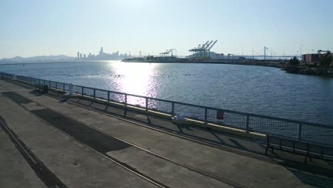 Smooth-slide-left-with-large-shipping-cranes-in-the-distance-in-San-Francisco-California-on-a-sunny-day-in-October