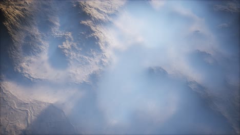 distant mountain range and thin layer of fog on the valleys