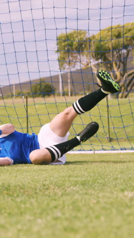 goalkeeper in blue making a save