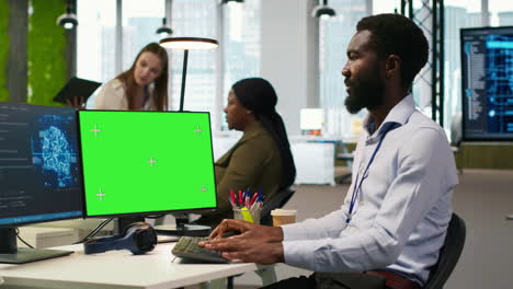 software developer using ai on green screen computer to optimize performance