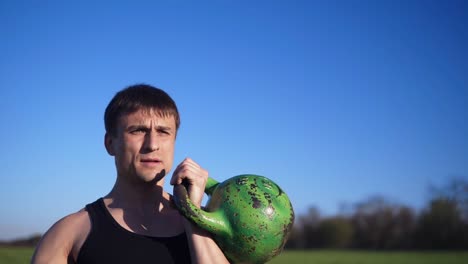 close up footage of a man exercising with weight. pumping hand muscles. caucasian. open area