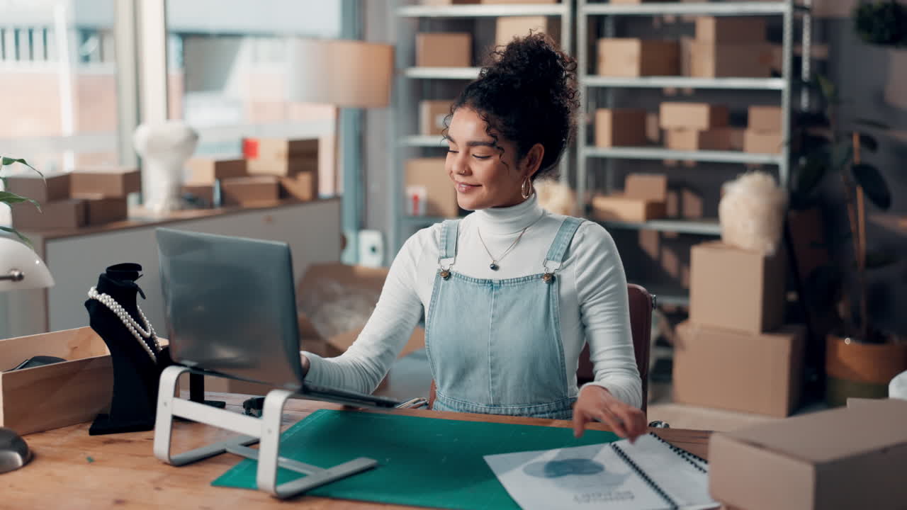 Woman working on laptop in home office for her small online business