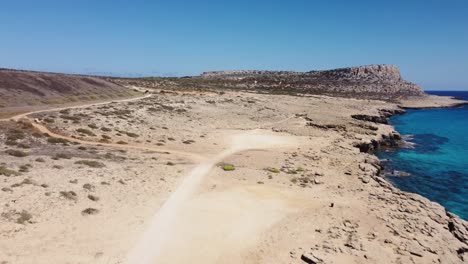 Aerial-Drone-Shot-of-a-dried-out-Landscape-on-the-Coast-of-Cyprus