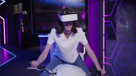 teenager experiencing vr motorcycle ride in an arcade