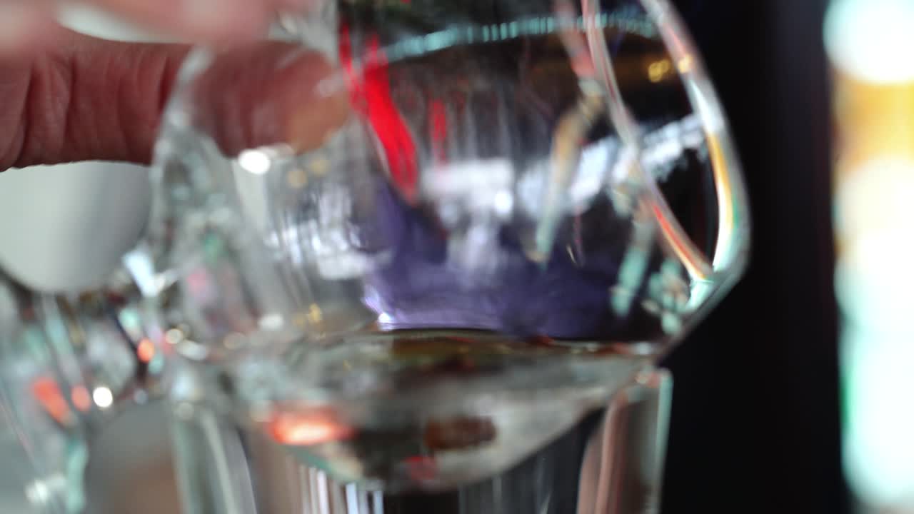 Bartender prepares Sambuca at the bar. Mixing of alcoholic drinks.