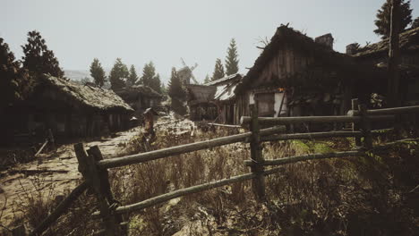 Abandoned village with rustic houses and a windmill at dusk