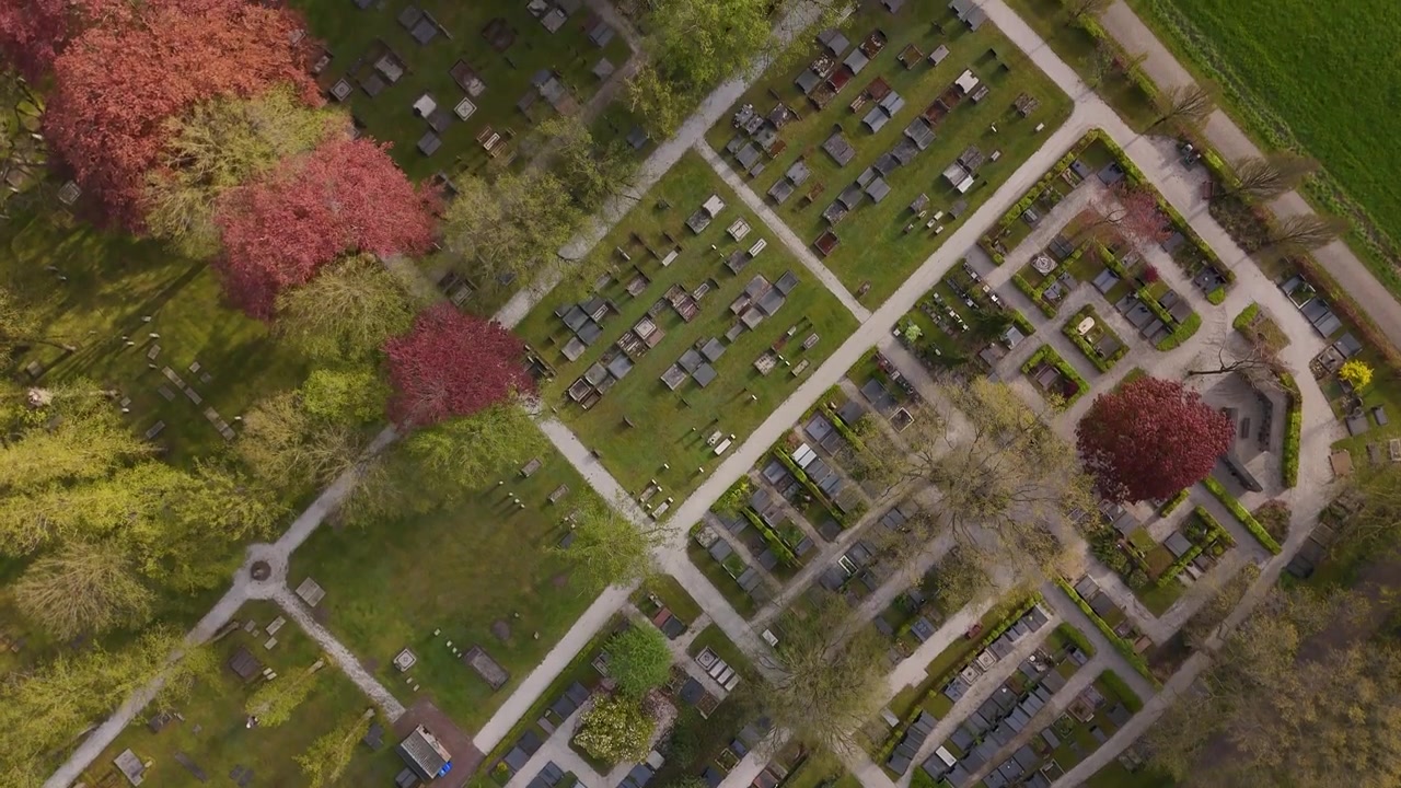 Aerial View of a Peaceful Cemetery Surrounded by Lush Green Trees