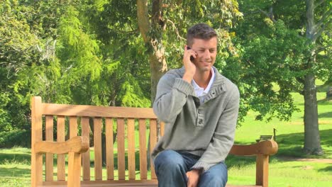 young man having a phone conversation outdoors