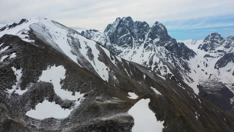 Drone-shot-revealing-the-snow-covered-Georgian-Dolomites-in-the-Caucasus-mountains-in-Georgia