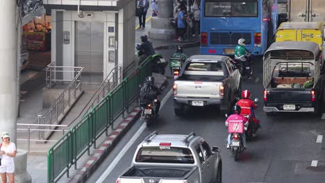 vehicles and motorcycles navigating a city road